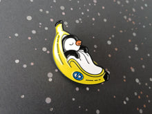 Load image into Gallery viewer, Penguin pin, penguin sleeping in a banana enamel pin, banana moon, fruit, food enamel badge