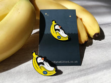 Load image into Gallery viewer, Penguin pin, penguin sleeping in a banana enamel pin, banana moon, fruit, food enamel badge