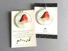 Load image into Gallery viewer, A keyring made from recycled acrylic with a robin design. With a choice of plain backing card or with the wording when a robin appears around you, it's just to say hello, and tell you that you're always loved, more than you'll ever know