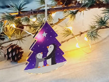 Load and play video in Gallery viewer, Penguin and star decoration. Eco friendly, purple recycled acrylic Christmas ornament, penguins in the snow