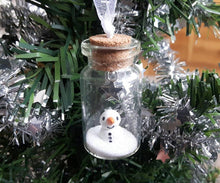 Load image into Gallery viewer, Miniature snowman decoration. Little pottery snowman in a glass bottle. Christmas mini ornament