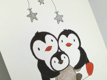 Load image into Gallery viewer, Cute penguin family print, two penguins and a baby chick, with three glitter stars above. 
