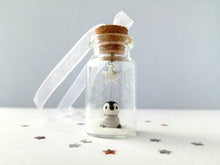 Load image into Gallery viewer, Miniature penguin decoration. Little pottery penguin chick in a glass bottle. Christmas mini penguin ornament