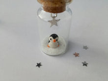 Load image into Gallery viewer, Miniature penguin decoration. Little pottery penguin in a glass bottle. Christmas penguin mini ornament
