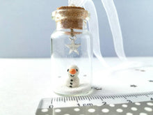 Load image into Gallery viewer, Miniature snowman decoration. Little pottery snowman in a glass bottle. Christmas mini ornament