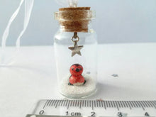 Load image into Gallery viewer, Robin Christmas decoration. Little pottery robin in a mini glass bottle. Miniature Christmas robin ornament