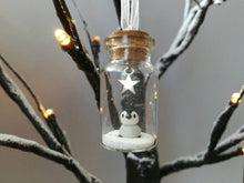 Load image into Gallery viewer, Miniature penguin decoration. Little pottery penguin chick in a glass bottle. Christmas mini penguin ornament