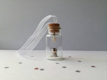 Load image into Gallery viewer, Miniature penguin decoration. Little pottery penguin chick in a glass bottle. Christmas mini penguin ornament