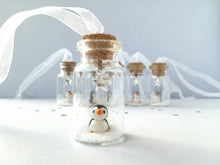 Load image into Gallery viewer, Miniature penguin decoration. Little pottery penguin in a glass bottle. Christmas penguin mini ornament