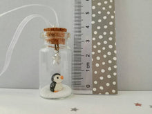 Load image into Gallery viewer, Miniature penguin decoration. Little pottery penguin in a glass bottle. Christmas penguin mini ornament
