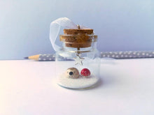 Load image into Gallery viewer, Miniature hedgehog and red toadstool Christmas decoration. Little pottery hedgehog in a glass bottle. Christmas woodland mini ornament