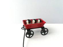 Load image into Gallery viewer, Miniature penguins in a cart. Little pottery penguin chicks in a red truck. Cute penguins
