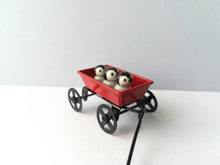 Load image into Gallery viewer, Miniature penguins in a cart. Little pottery penguin chicks in a red truck. Cute penguins