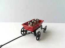 Load image into Gallery viewer, Miniature penguins in a cart. Little pottery penguin chicks in a red truck. Cute penguins