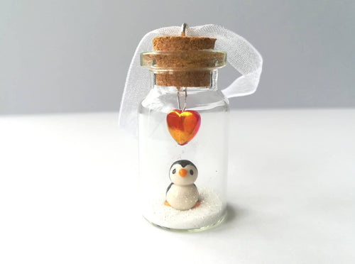 Miniature penguin gift. Little pottery penguin in a glass bottle. Red love heart mini penguin ornament