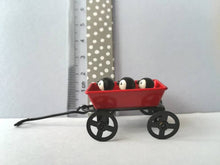 Load image into Gallery viewer, Miniature penguins in a cart. Little pottery penguin chicks in a red truck. Cute penguins
