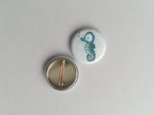 Load image into Gallery viewer, Back and front of a seahorse badge

