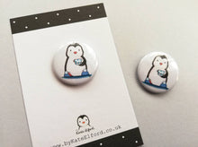 Load image into Gallery viewer, Little penguin button badge, a black and white penguin wearing slippers with pom poms and a polka dot cup and saucer