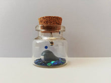 Load image into Gallery viewer, Miniature whale ornament. Little pottery whales in a glass bottle. Puffin mini ornament with or without hook