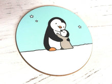Load image into Gallery viewer, Penguin coaster. A black and white penguin and a grey penguin chick in the snow hugging. There is a light blue sky with a few stars
