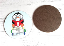 Load image into Gallery viewer, Book coaster, penguin, one more page, rainbow colours, pale blue table mat, book lover
