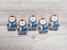 Load image into Gallery viewer, A row of five penguin magnets, wearing dressing gowns and slippers