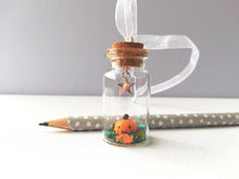 Load image into Gallery viewer, Miniature pumpkin decoration. Little pottery pumpkin in a glass bottle. Halloween mini star autumn ornament