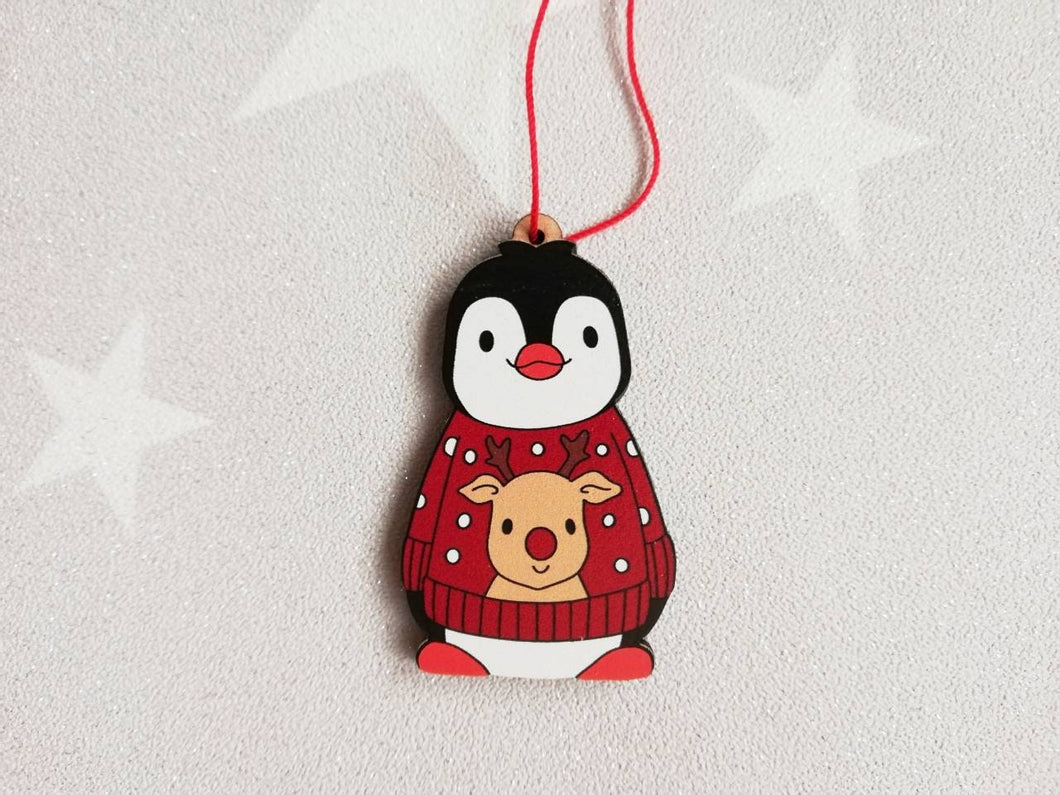 Penguin reindeer jumper decoration. Little wooden penguin wearing a blue or red jumper Christmas ornament, responsibly resourced wood