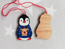 Load image into Gallery viewer, Penguin reindeer jumper decoration. Little wooden penguin wearing a blue or red jumper Christmas ornament, responsibly resourced wood
