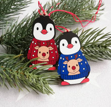 Load image into Gallery viewer, Penguin reindeer jumper decoration. Little wooden penguin wearing a blue or red jumper Christmas ornament, responsibly resourced wood