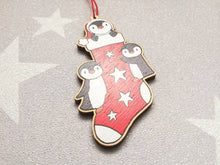 Load image into Gallery viewer, Penguin Christmas stocking decoration. Wooden penguins Christmas tree ornament. Red and white stocking with stars, eco friendly wood