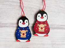 Load image into Gallery viewer, Penguin reindeer jumper decoration. Little wooden penguin wearing a blue or red jumper Christmas ornament, responsibly resourced wood
