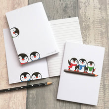 Load image into Gallery viewer, A6 notebook, cute penguins sat on a pencil. Small lined notepad
