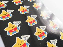 Load image into Gallery viewer, An A6 sticker sheet, with gold star for a super star written on it. There are lots of little star stickers in blue capes and red pants holding a flag saying super