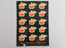 Load image into Gallery viewer, An A6 sticker sheet, with gold star for a super star written on it. There are lots of little star stickers in blue capes and red pants holding a flag saying super