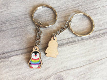 Load image into Gallery viewer, Little penguin keyring, cute rainbow mini tag, wooden key chain, penguin wearing a jumper, ethically sourced wood, eco friendly charm