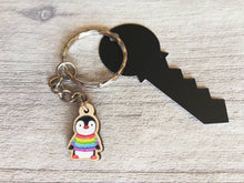 Load image into Gallery viewer, Little penguin keyring, cute rainbow mini tag, wooden key chain, penguin wearing a jumper, ethically sourced wood, eco friendly charm
