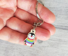 Load image into Gallery viewer, Little penguin keyring, cute rainbow mini tag, wooden key chain, penguin wearing a jumper, ethically sourced wood, eco friendly charm