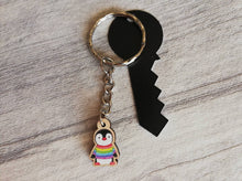Load image into Gallery viewer, Little penguin keyring, cute rainbow mini tag, wooden key chain, penguin wearing a jumper, ethically sourced wood, eco friendly charm