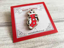 Load image into Gallery viewer, Christmas stocking pin, penguin wooden pin brooch, Responsibly resourced wood, eco friendly. Christmas penguins stocking filler