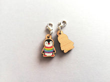 Load image into Gallery viewer, Back and front of a small wooden stitch marker, little penguin design wearing a rainbow striped jumper
