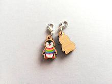 Load image into Gallery viewer, Back and front of a small wooden stitch marker, little penguin design wearing a rainbow striped jumper