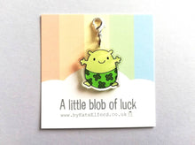 Load image into Gallery viewer, A little blob of luck stitch marker. Recycled acrylic charm with a silver plated lobster clasp. Blob is a happy little character wearing four leaf clover lucky pants.
