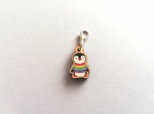 Load image into Gallery viewer, Small wooden stitch marker, little penguin design wearing a rainbow striped jumper