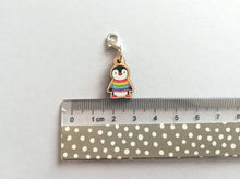Load image into Gallery viewer, Small wooden stitch marker, little penguin design wearing a rainbow striped jumper