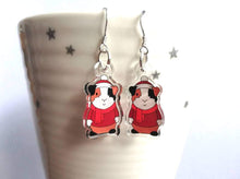 Load image into Gallery viewer, Clear recycled guinea pig earrings, wearing red jumpers, scarves and a Christmas santa hat
