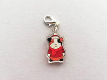 Load image into Gallery viewer, Little clear acrylic guinea pig stitch marker. It is made from recycled acrylic, the guinea pig is wearing a red hat, jumper and scarf