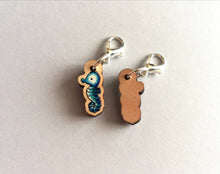 Load image into Gallery viewer, Seahorse stitch marker, mini blue seahorse wooden charm, ethically sourced wood, little crochet stitch marker

