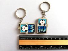 Load image into Gallery viewer, Penguin keyring, sleeping penguin sardine tin, lightweight wooden key fob, ethically sourced wood, penguin key chain, cute bag charm