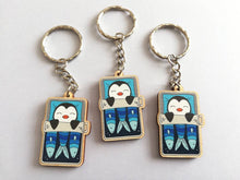 Load image into Gallery viewer, Penguin keyring, sleeping penguin sardine tin, lightweight wooden key fob, ethically sourced wood, penguin key chain, cute bag charm